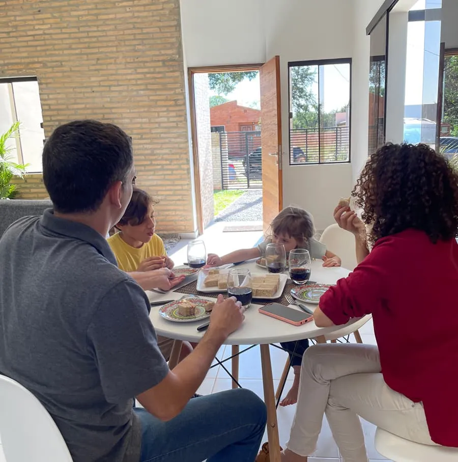 Familia comiendo en el comedor de casa más